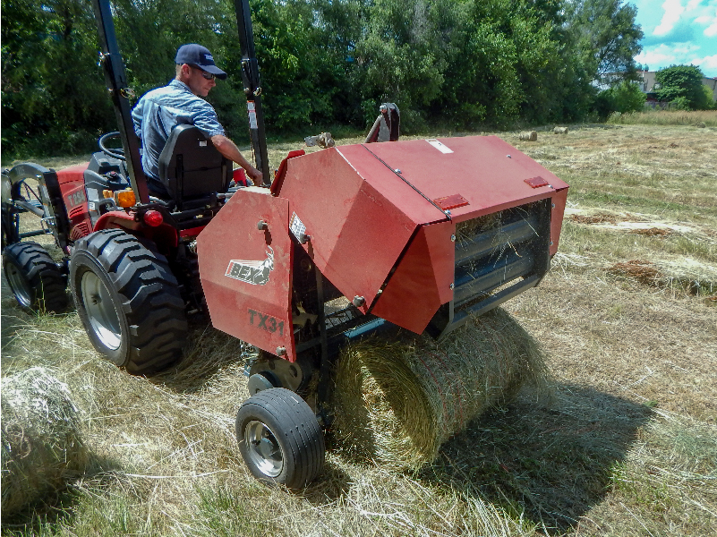 Ejecting a bale from an Ibex TX31 Mini Round Baler with Twine Wrap. 