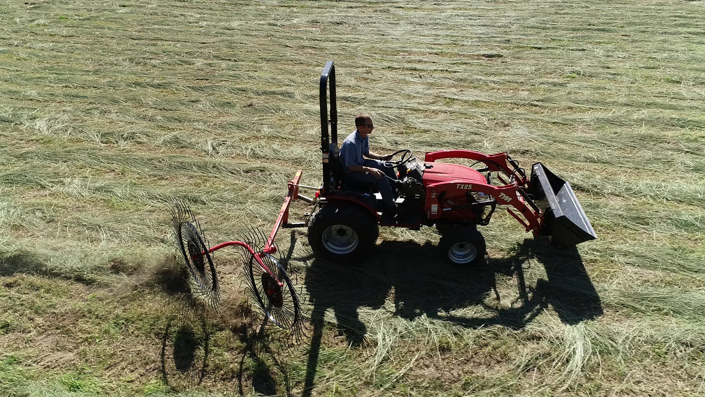 Raking hay with an Ibex TX51 Wheel Rake. 